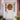 A white front door is decorated for autumn. A wreath of leaves, berries, and small pumpkins is centered on the door. Pumpkins, gourds, mums, and small potted plants adorn the steps leading to the door, creating a festive fall display.