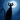A stylized illustration depicts a black cat sitting upright, facing forward, with wide white eyes and prominent whiskers. It is silhouetted against a deep blue, textured night sky filled with scattered white stars, with a large, bright full moon positioned behind its head to the upper right. The cat's dark body also features small scattered white and light blue stars, and its long, curved tail rests gracefully beside it, with a subtle shadow beneath its paws.