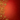A vibrant, deep red background features intricate, shimmering golden scrollwork and various stylized snowflake and floral-like designs. These opulent gold embellishments are concentrated along the left and bottom edges of the frame, providing ample clear space on the right and top for text. The red background itself has a subtle, embossed texture of smaller snowflake patterns, creating a rich and festive visual with a sense of depth and luxury.