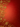 A vibrant, deep red background features intricate, shimmering golden scrollwork and various stylized snowflake and floral-like designs. These opulent gold embellishments are concentrated along the left and bottom edges of the frame, providing ample clear space on the right and top for text. The red background itself has a subtle, embossed texture of smaller snowflake patterns, creating a rich and festive visual with a sense of depth and luxury.