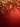 A vertical background image showcasing shimmering golden and red snowflakes hanging from the top against a soft-focus bokeh of golden lights. The backdrop features a rich, gradient red color, brightening at the top and darkening towards the bottom, with subtle golden light particles scattered throughout. This elegant holiday visual provides clear space below the decorations for text or design overlays.