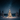 A beautifully illuminated Christmas tree covered in white snow stands centrally in a vast, pristine winter landscape under a dark, star-filled night sky. Warm golden lights adorn the evergreen tree, casting a gentle glow on the surrounding snow, while distant snow-covered forest trees line the horizon under the deep blue starry expanse.