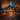 A two-story house is decorated for Halloween at dusk. Carved pumpkins with lights inside line the walkway and are placed along the front of the house. The lawn and pathway are covered in fallen orange and brown leaves, and the house windows are lit from within.