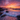 A breathtaking view of a beach at sunset. The sky is filled with vibrant pink and orange clouds, reflecting on the gentle waves. Dark rocks line the shore, creating a dramatic contrast with the colorful sky and the foamy water.