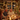 A warm, inviting image of a diverse family or group of friends sharing a joyful holiday dinner around a beautifully decorated table. The scene is illuminated by soft, golden Christmas string lights and glowing candles, with a large, decorated Christmas tree visible in the background. People are laughing and smiling, enjoying food and red wine, conveying a strong sense of togetherness and festive celebration.