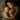An overhead shot shows a mother and young son sleeping side-by-side in bed. The child is holding a brown teddy bear, and the mother has her eyes closed, resting her head near the child's. They are both covered in a white duvet. The scene evokes feelings of love, safety, and peacefulness.