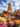 A medium shot displays a whimsical scarecrow standing on stacked hay bales. The scarecrow is wearing an orange plaid shirt, white pants, and brown boots, and has a smiling face painted on its pumpkin head. Pumpkins and potted mums of various colors surround the base of the hay bales creating a festive fall scene with a clear blue sky and soft white clouds in the background.