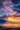 A breathtaking mountain landscape at sunrise. The sky is filled with colorful clouds of blue, purple, pink and orange while golden sunbeams shine through. A layer of fog covers the valley below with trees appearing on the hills.