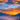 A vertical landscape photograph depicts a mountain valley at sunrise. Silhouetted mountain ranges recede into the distance beneath a vibrant sky filled with orange and yellow clouds. A thick blanket of fog fills the valley floor, obscuring the details of the landscape below, creating a mystical and dreamlike atmosphere.