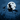 A digital illustration shows a black silhouette of a witch riding a broomstick across the night sky. A black cat sits on the broomstick behind the witch, and several black bats fly around them. A large, pale moon illuminates the scene, and a dark field of corn stalks stretches across the lower part of the image.