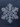 A stunning, highly detailed macro photograph of a single, perfectly formed snowflake centered against a dark, muted bluish-gray background. The transparent ice crystal exhibits intricate hexagonal symmetry with branching arms, sharp facets, and subtle internal refractions, highlighting its delicate natural beauty and complex structure.