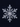 A highly detailed, perfectly symmetrical snowflake is centered against a dark, textured navy blue background. The snowflake, appearing in shades of translucent white and silver with blue reflections, features intricate six-pointed branches and delicate sub-branches, showcasing its complex crystalline structure with sharp facets. Bright highlights emphasize its three-dimensional form and sparkling quality.