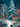 A captivating digital illustration depicting two deer in a snowy winter forest at twilight. A larger, slender deer stands in the foreground facing right, while a smaller deer with antlers is visible further back to the left, looking towards the front deer. The scene is rich with snow-covered evergreen trees, bare white-barked trees, and lush foreground foliage in shades of teal, gold, and coral, all accented by gently falling snow.