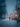 A picturesque vertical shot of a person walking away from the viewer on a snow-covered street at night. The street is lined with traditional houses and bare trees, all illuminated by countless warm, golden Christmas lights, creating a magical and cozy winter wonderland atmosphere under gently falling snow.