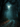 A full moon shines brightly through a misty, dark forest canopy at night. A winding dirt path covered with fallen orange and brown autumn leaves leads into the deep woods, disappearing into the thick blue-green fog. The scene evokes a mysterious and tranquil atmosphere.