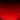 An abstract background image featuring a vertical color gradient transitioning from solid black at the top to a rich, vibrant red at the bottom. The red area is heavily textured with small, scattered black and red speckles, resembling fine dust, glitter, or sparks. The density of these particles increases significantly towards the bottom edge, creating a visually dynamic and textured effect.