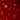 An intricate, seamless pattern of stylized snowflakes in various shades of red and crimson against a deep, dark red background. Some snowflakes are sharply defined with fine details and lighter highlights, while others are darker or slightly blurred, creating visual depth. Small scattered dots resembling falling snow or glitter further enhance the festive and elegant appearance.