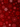 An intricate, seamless pattern of stylized snowflakes in various shades of red and crimson against a deep, dark red background. Some snowflakes are sharply defined with fine details and lighter highlights, while others are darker or slightly blurred, creating visual depth. Small scattered dots resembling falling snow or glitter further enhance the festive and elegant appearance.