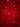 A vertically oriented image featuring a vibrant, deep red background with a dense, intricate pattern. The pattern consists of numerous holiday-themed motifs, including detailed snowflakes, various stylized ornaments like baubles, bells, and lanterns, and other abstract festive shapes. These elements are rendered in shades of red, from crimson to lighter scarlet, creating a textured, glowing effect suitable for a holiday or winter theme.
