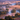 An aerial view of a winding river flowing through a misty valley at sunrise. Thick, soft fog blankets the lower landscape, with lush green and golden-orange trees emerging from the ethereal mist. The sky is a warm gradient of pink and orange, casting a magical glow over the tranquil and beautiful natural scene.
