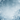 A vertical image depicting a serene winter scene. The top and sides are framed by large, intricate white snowflakes, while a soft snowfall of smaller white specks fills the ethereal blue gradient background. Frosted, bare tree branches covered in ice and snow are visible along the bottom edge, creating a peaceful and magical winter wonderland ambiance.