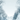 An illustrated vertical image of a serene winter scene. A snow-covered path leads through a forest, flanked by trees and bushes heavily laden with snow and ice. Bare branches and evergreen foliage are frosted white, and numerous white snowflakes are depicted actively falling against a soft light blue-grey sky, creating a peaceful and ethereal winter atmosphere.