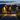 A man, a young girl, and a young boy walk hand-in-hand down a paved path at dusk, their backs to the viewer. They are approaching a row of modern wooden cabins with warm lights glowing from their entrances, under a dark blue sky with faint clouds. The scene conveys a sense of peaceful family time and arrival at a cozy destination.