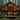 A modern, dark-colored A-frame cabin with large glass windows illuminating warm, golden light from within. The cabin is situated on a spacious wooden deck with outdoor lounge furniture, enveloped by a dense forest of tall evergreen trees and vibrant green ferns on the ground, conveying a sense of luxurious, peaceful retreat in nature.
