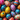 An overhead view of numerous vibrantly colored Easter eggs, densely packed and filling the entire image frame. The eggs are individually decorated with a variety of intricate patterns including polka dots, geometric lines, abstract splatters, and floral designs, in a broad spectrum of colors such as pink, blue, yellow, orange, red, and green, creating a rich tapestry of festive details.