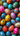 An overhead view of numerous vibrantly colored Easter eggs, densely packed and filling the entire image frame. The eggs are individually decorated with a variety of intricate patterns including polka dots, geometric lines, abstract splatters, and floral designs, in a broad spectrum of colors such as pink, blue, yellow, orange, red, and green, creating a rich tapestry of festive details.