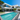 A stunning, multi-story white modern villa with expansive black-framed windows is situated next to a long, rectangular turquoise swimming pool. The property is surrounded by lush green landscaping, including a large mature tree on the left and palm trees on the right. Light grey paved patios and walkways define the meticulously maintained outdoor spaces under a clear, bright blue sky.