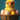A vibrant, close-up shot of an extremely fluffy yellow baby chick wearing bright pink, circular-framed glasses. The chick is seated inside a woven brown wicker basket, surrounded by pastel-colored, speckled Easter eggs in shades of pink, cream, and yellow. The background is a soft, blurred teal-blue color, providing a cheerful contrast to the main subject.