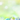 A vertical image featuring four pastel-colored Easter eggs with intricate white designs, resting in a nest of green hay. The eggs are teal, pink, lime green, and lavender blue, arranged on a weathered wooden surface. The background is a soft, blurry bokeh of bright green and yellow, suggesting an outdoor spring setting with soft natural light.