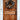 A vertical shot of a warm reddish-brown paneled wooden front door, featuring visible wood grain. A decorative autumnal wreath, made of deep green leaves, white berries, and burnt orange dried flowers, hangs in the upper center. The door is framed by crisp white trim and white horizontal siding, with a black traditional handle and deadbolt on the right, conveying a welcoming and seasonally decorated home entrance.