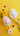 A vibrant flat lay image showcasing two white, decorative eggs adorned with numerous small, multi-colored hearts. They are arranged diagonally on a bright yellow background, which is also sprinkled with smaller heart-shaped confetti in various colors. A yellow flower with green leaves is positioned in the top left corner, and a white daisy-like flower with green foliage is in the bottom right, adding natural accents to this cheerful, festive composition.