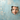 Professional surprised man peeking through textured blue wall hole - high-quality image for marketing and content creation